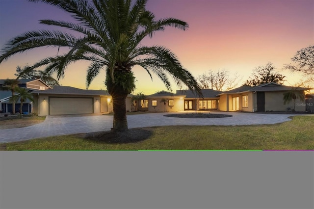 view of front of home featuring a garage and a yard