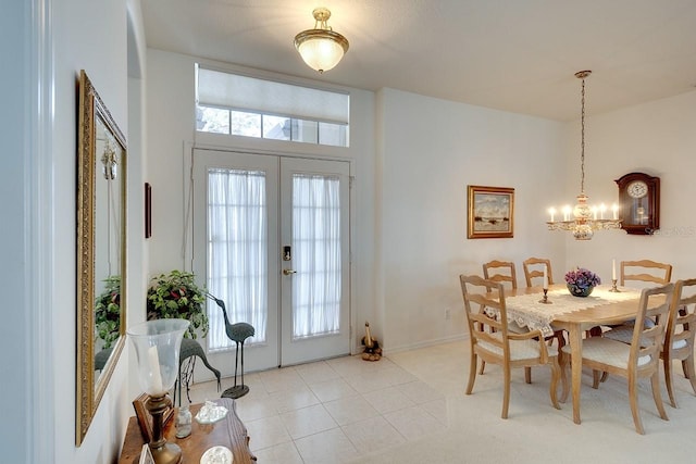 dining area featuring a notable chandelier, light tile patterned flooring, and french doors