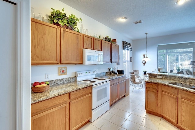 kitchen featuring white appliances, hanging light fixtures, light stone countertops, a textured ceiling, and light tile patterned flooring