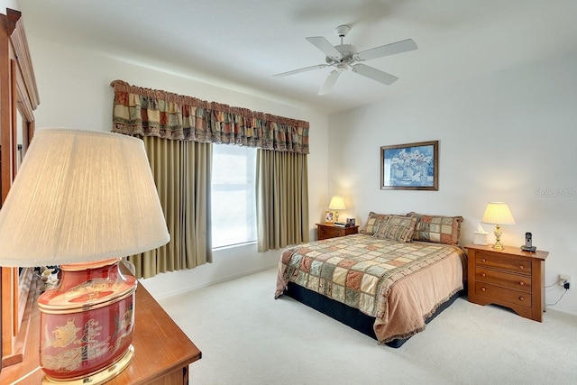 bedroom with ceiling fan and light carpet