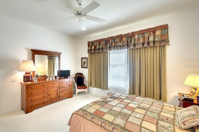 bedroom featuring ceiling fan and light carpet