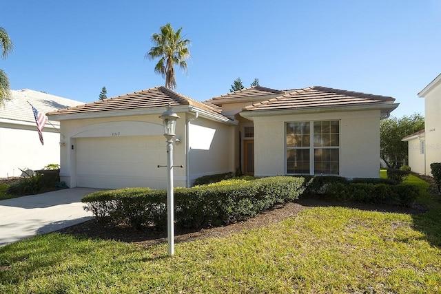 view of front of home with a garage and a front lawn