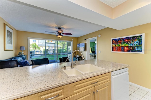 kitchen featuring ceiling fan, dishwasher, light brown cabinets, and sink