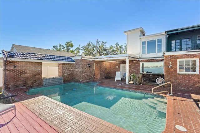 view of swimming pool with a patio and a wooden deck