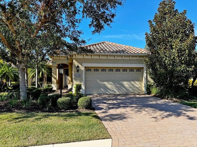 mediterranean / spanish house featuring a garage