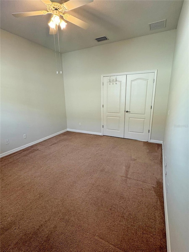 carpeted empty room with ceiling fan