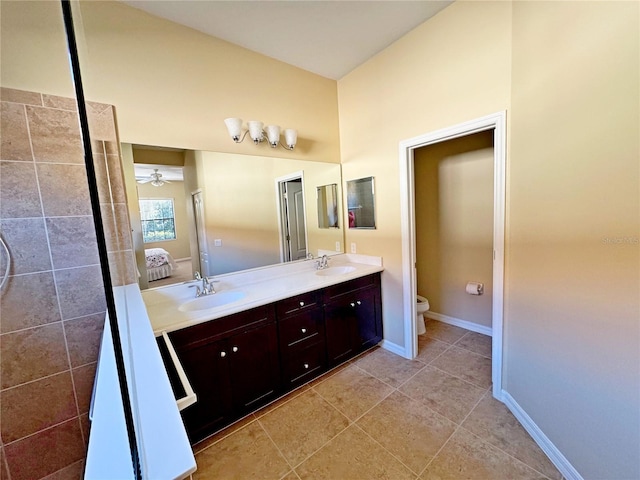 bathroom with tile patterned floors, vanity, ceiling fan, and toilet