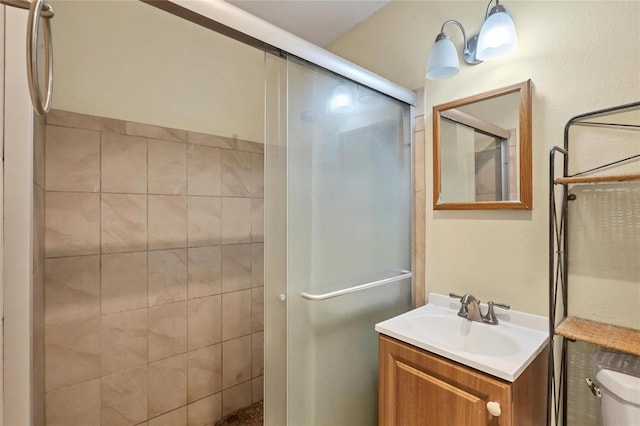 bathroom with vanity and a shower with shower door