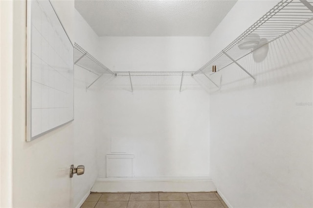 walk in closet featuring light tile patterned flooring