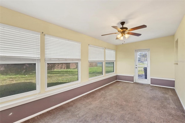 unfurnished sunroom featuring ceiling fan