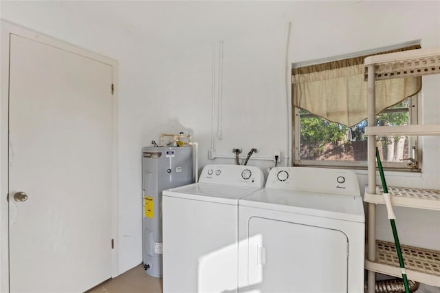 clothes washing area with separate washer and dryer and electric water heater