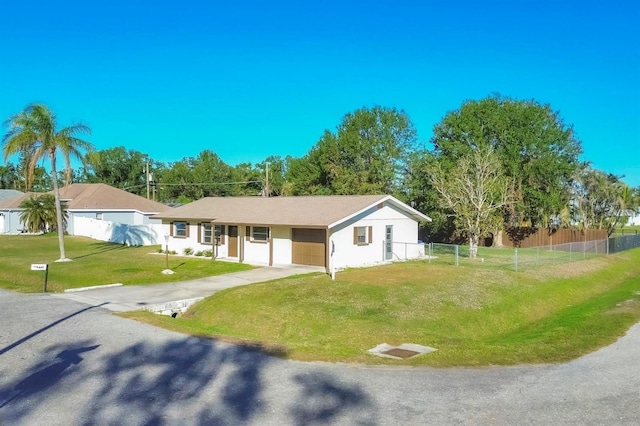 single story home featuring a garage and a front lawn