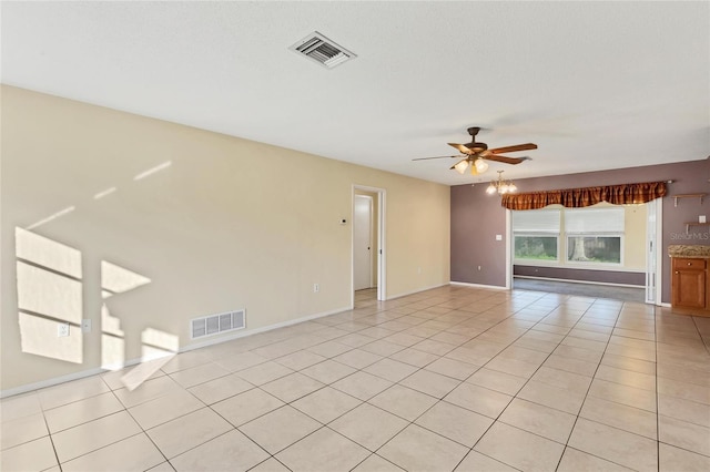 empty room featuring ceiling fan and light tile patterned floors