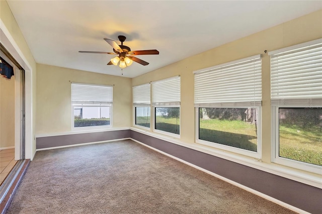 unfurnished sunroom with a wealth of natural light and ceiling fan