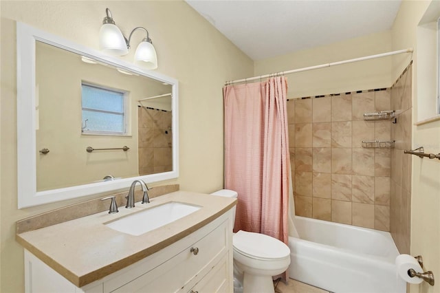 full bathroom with vanity, shower / bath combo, and toilet