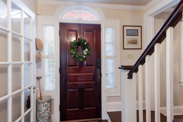 entryway with hardwood / wood-style flooring, plenty of natural light, and crown molding