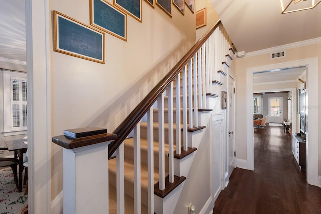 staircase with hardwood / wood-style flooring and crown molding