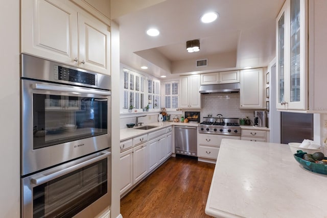 kitchen featuring dark hardwood / wood-style flooring, white cabinetry, and appliances with stainless steel finishes