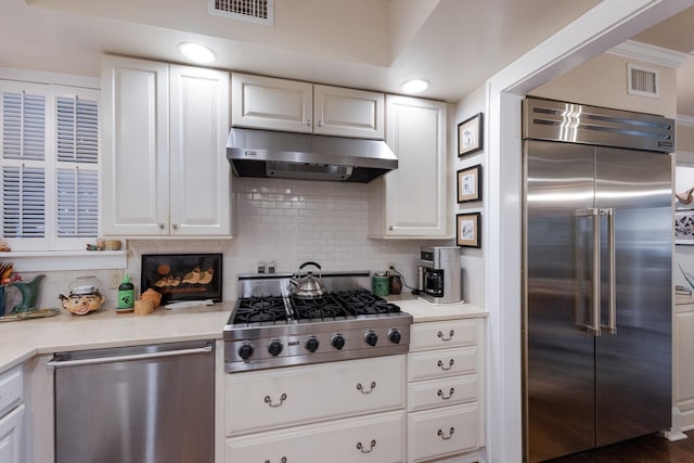 kitchen featuring visible vents, light countertops, appliances with stainless steel finishes, white cabinets, and under cabinet range hood