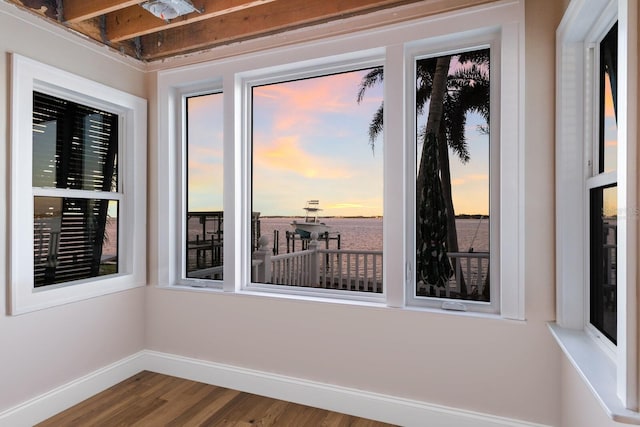 spare room with wood-type flooring and a water view