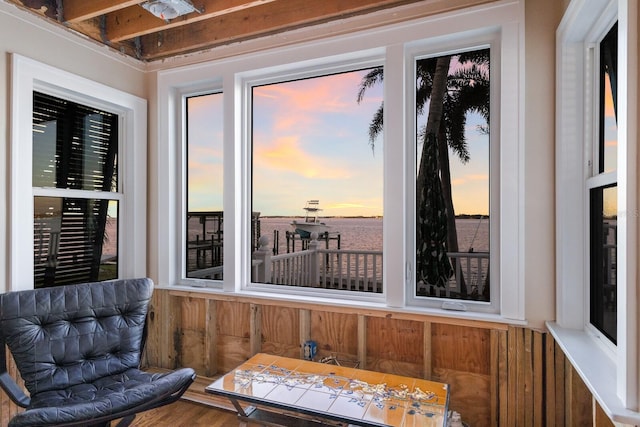 sunroom / solarium featuring a water view