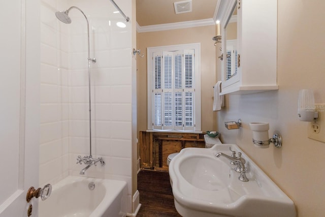 bathroom with hardwood / wood-style flooring, sink, crown molding, and bathtub / shower combination