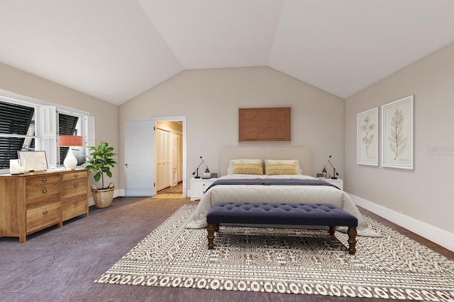 bedroom with ensuite bath, hardwood / wood-style floors, and lofted ceiling