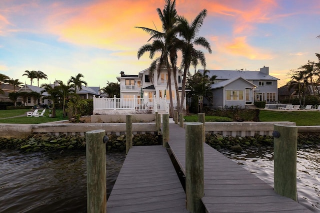 dock area featuring a residential view and a water view