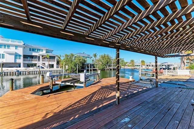 dock area with a pergola and a water view