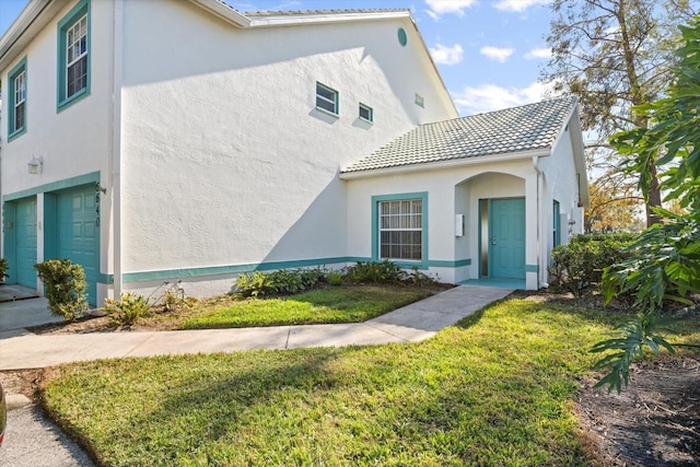 view of front facade with a front yard and a garage