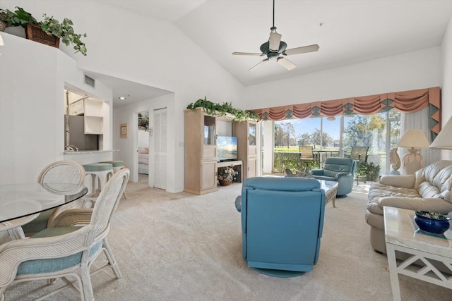 carpeted living room featuring ceiling fan and high vaulted ceiling