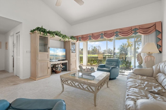 carpeted living room with high vaulted ceiling, ceiling fan, and a healthy amount of sunlight