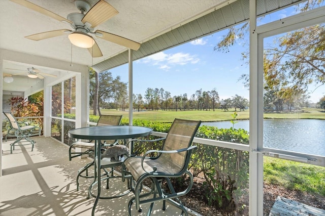 sunroom / solarium featuring a water view