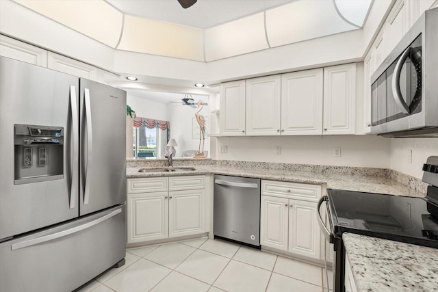 kitchen with white cabinets, appliances with stainless steel finishes, ceiling fan, and sink