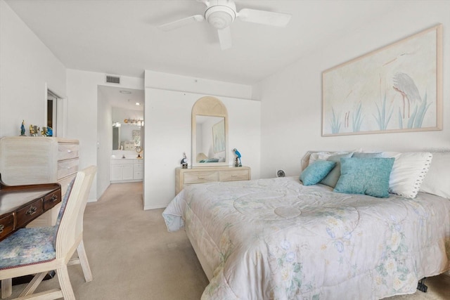 carpeted bedroom with ceiling fan and ensuite bathroom