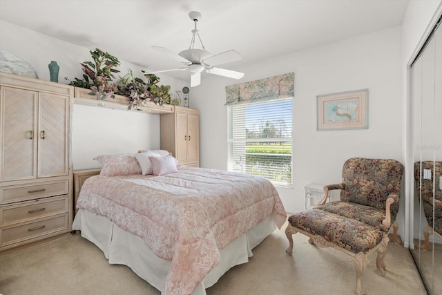 carpeted bedroom featuring ceiling fan and a closet