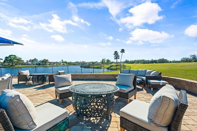 view of patio featuring outdoor lounge area and a water view