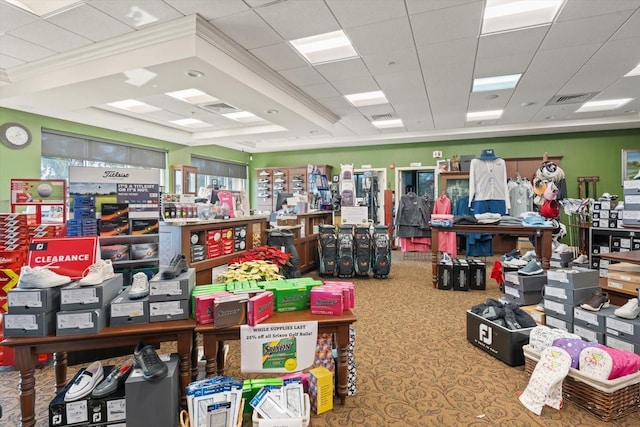 miscellaneous room featuring a drop ceiling, ornamental molding, and carpet floors