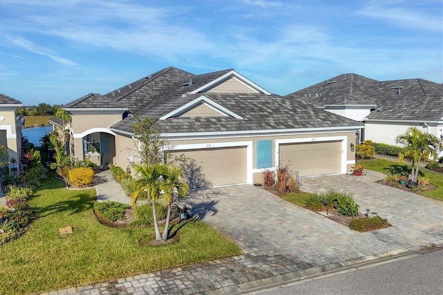 view of front of property with a garage and a front lawn