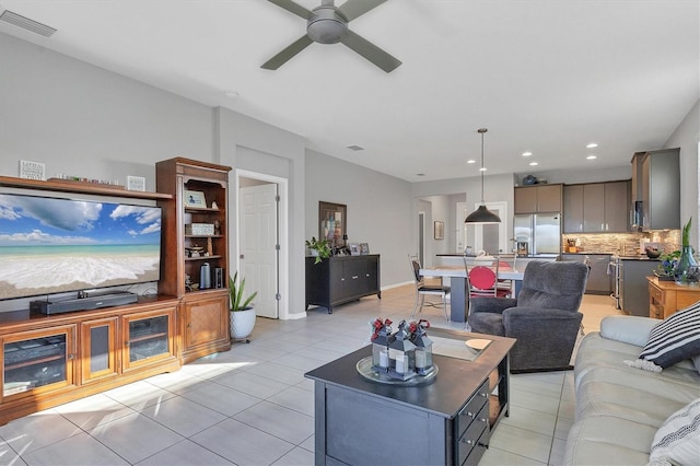 living room featuring light tile patterned floors and ceiling fan