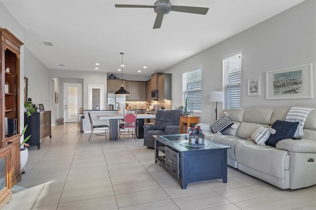 tiled living room featuring ceiling fan