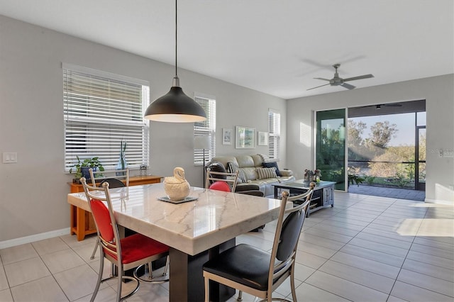 dining space featuring ceiling fan and light tile patterned floors