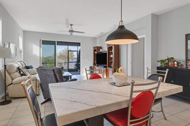 dining space with light tile patterned floors and ceiling fan