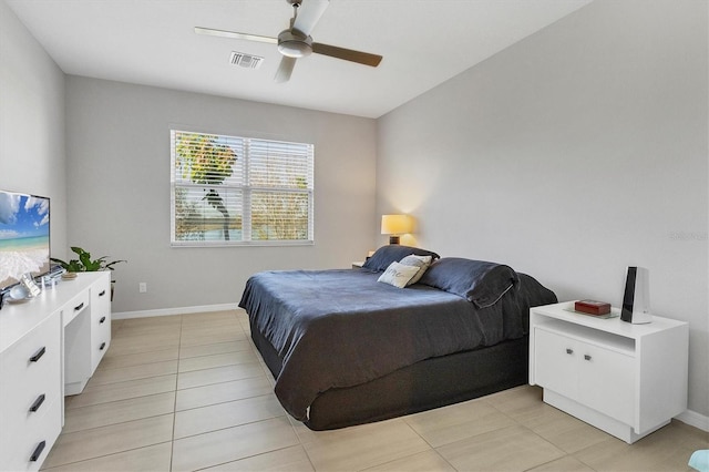 tiled bedroom featuring ceiling fan