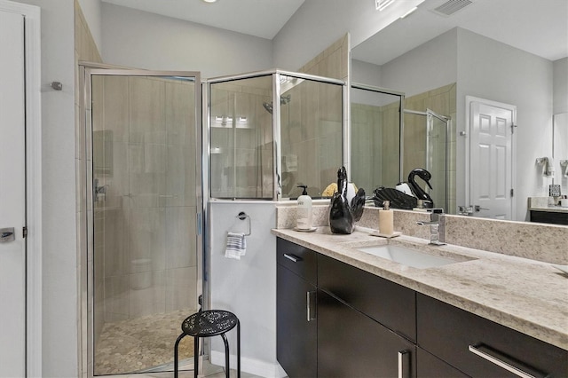 bathroom featuring vanity and an enclosed shower