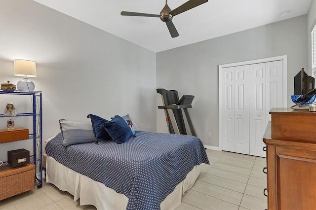 bedroom featuring light tile patterned flooring, a closet, and ceiling fan