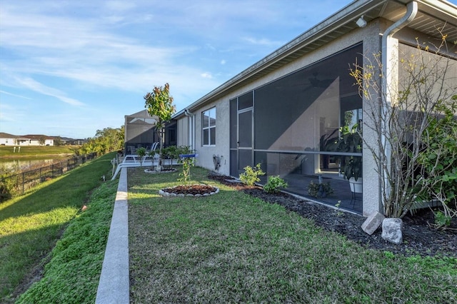 view of yard featuring a sunroom and a patio area