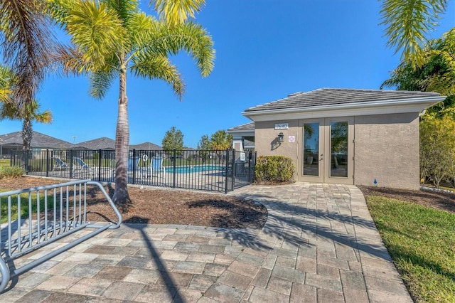 view of pool featuring french doors and a patio