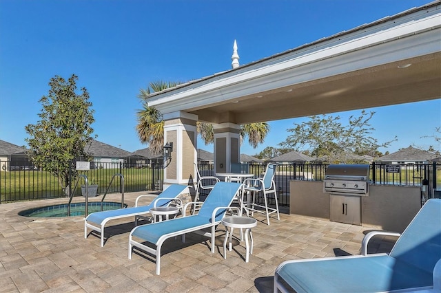 view of patio featuring a grill, a swimming pool, and area for grilling