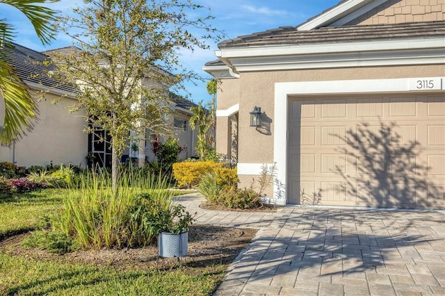 3115 Trustee Ave, Sarasota, FL 34243 - doorway to property featuring stucco siding and driveway